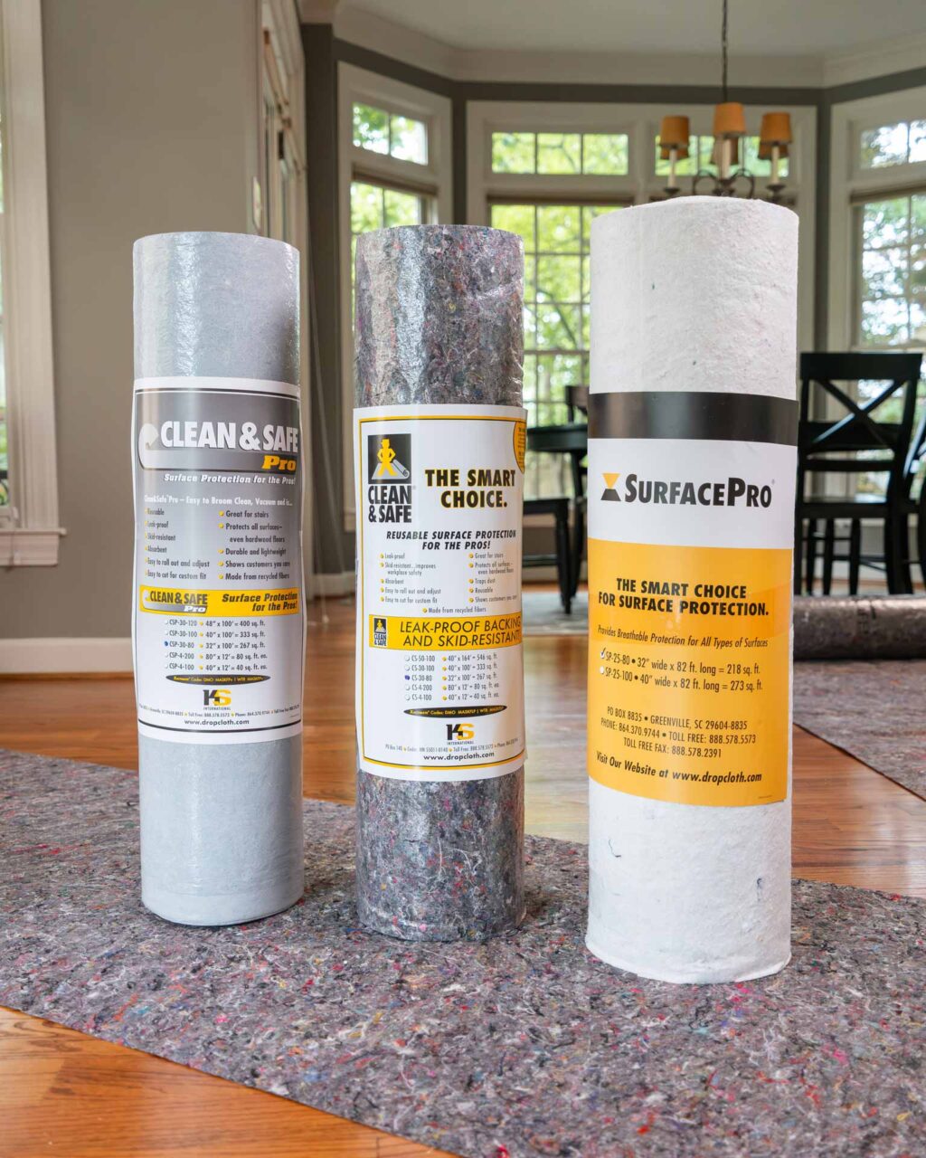 SurfaceGuard Pro™ rolls displayed in a sunlit room, showcasing protective floor coverings from a national dealer network.