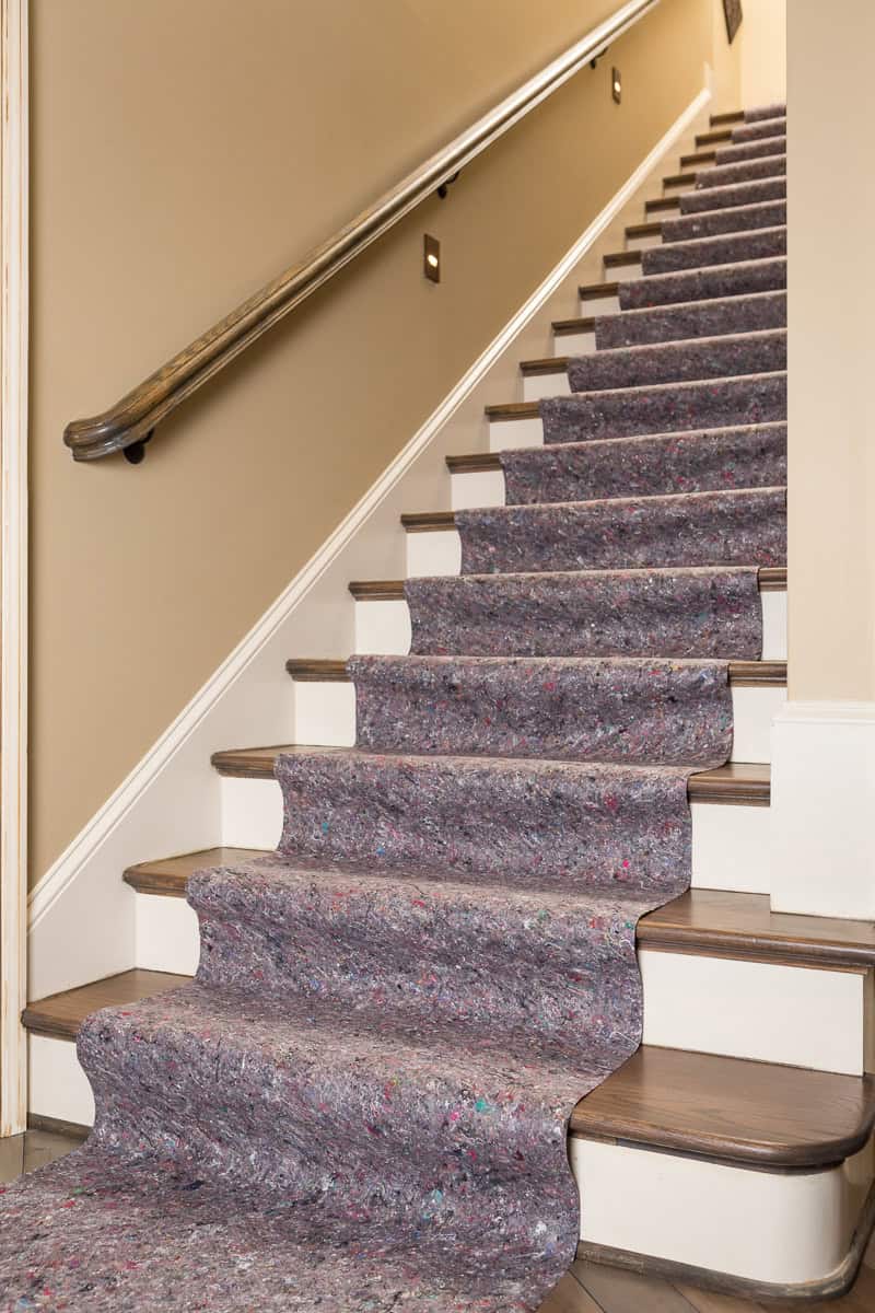 Staircase protected with SurfaceGuard Pro™ drop cloth, preventing damaged floors; your reputation depends on it.