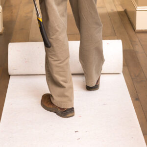 Rolling out SurfacePro® for thicker scratch and dent protection on site-finished floors.